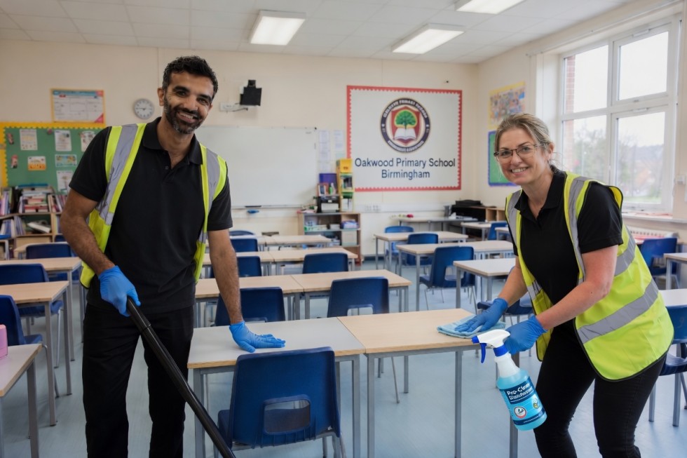 Clean360 Birmingham school cleaners – Professional team vacuuming and sanitising desks in a bright Birmingham primary school classroom